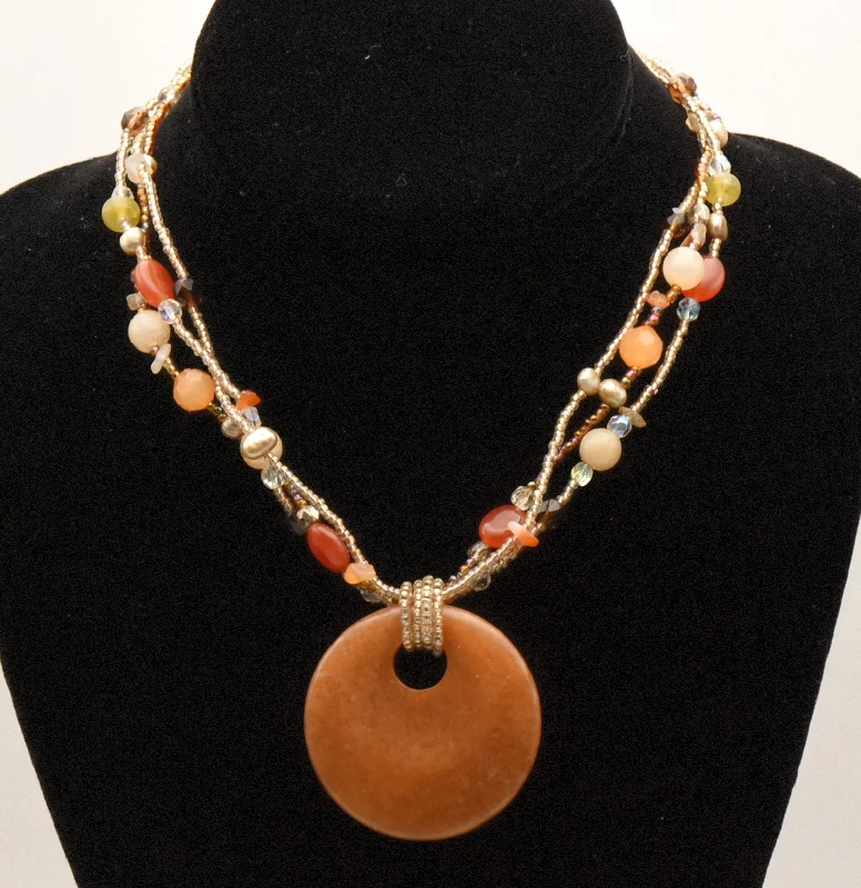 Trendy Layered Silver Necklace For Chic Look-Lia Sophia - Beaded Multi-Strand Orange Stone Pendant Necklace