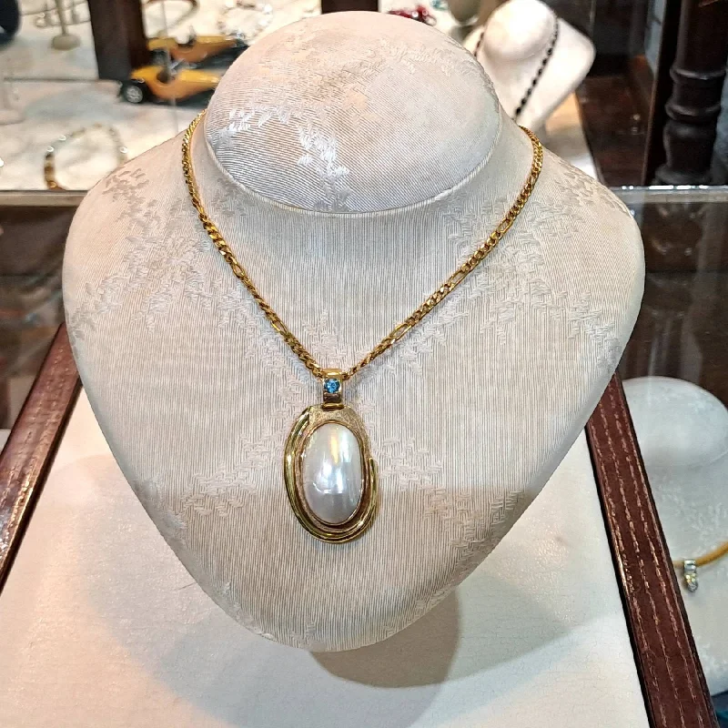 Simple Heart Pendant Necklace For Casual Look-Necklace with a 18k gold medallion mother of pearl and a bleu topaz in a hand made 18k. gold chain